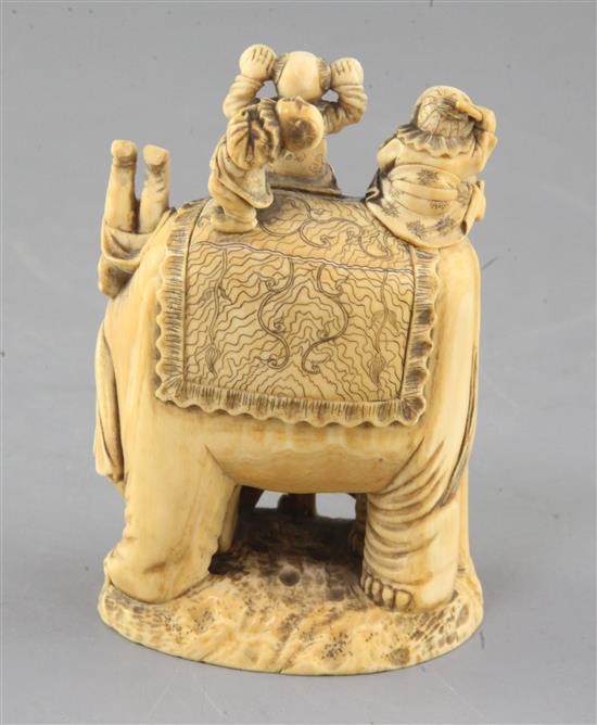 A Japanese ivory okimono of boys clambering on an elephant, Meiji period, height 9.8cm